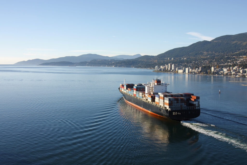 a loaded container ship leaving port