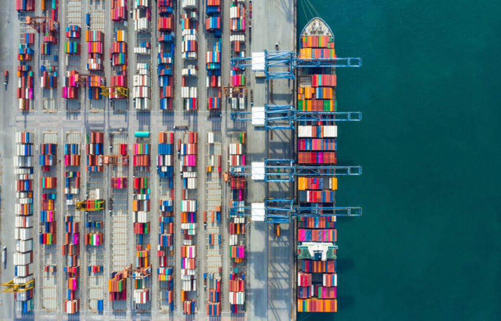 Aerial view container ship in port at container terminal port, Ship of container ship stand in terminal port on loading, unloading container, Commercial cargo ship in sea port.