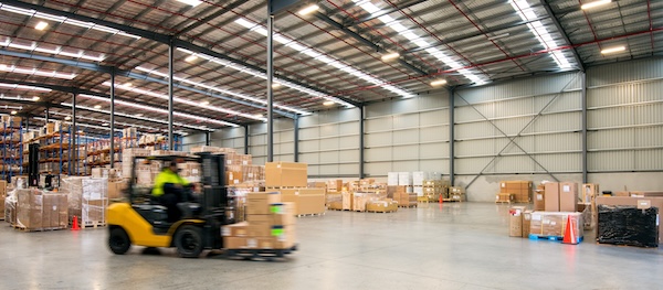 Forklift working at logistics warehouse.