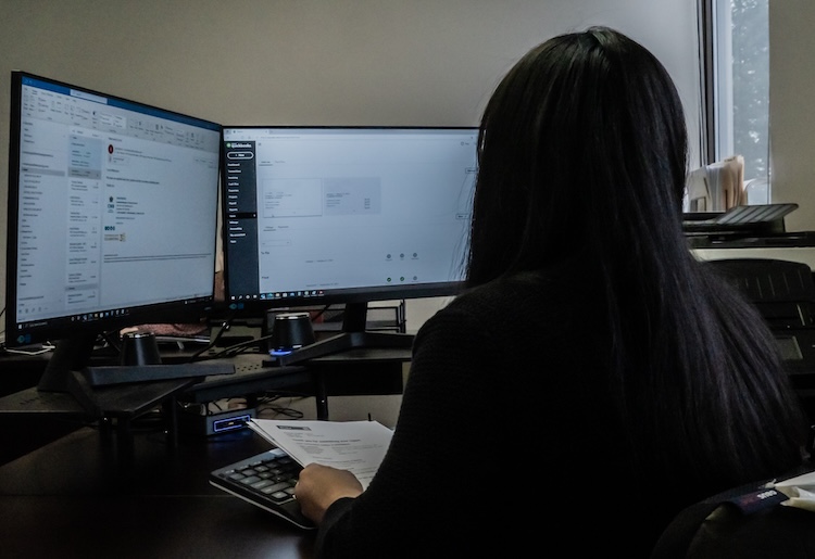 WTC employee working on the computers to track shipping logistics movement