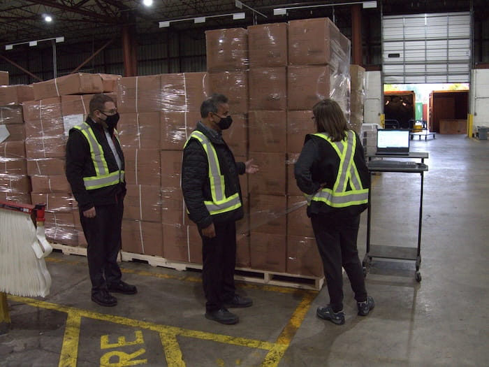 WTC Group employees at the warehouse discussing intermodal shipping services for clients.