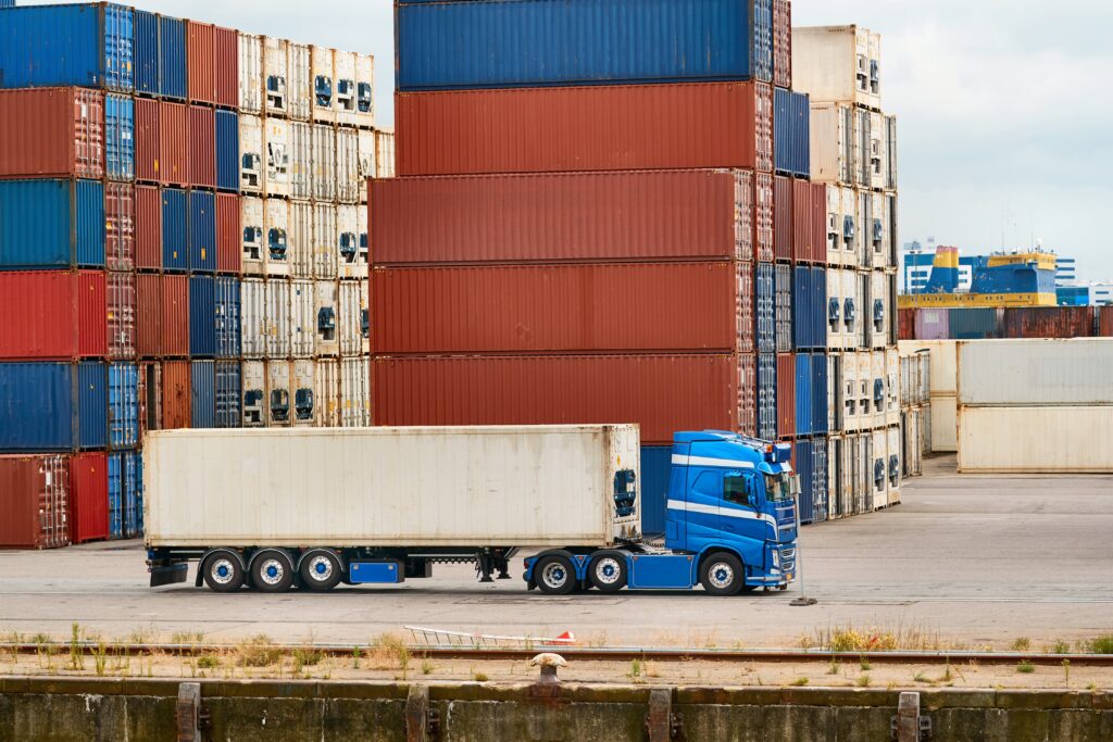 Container terminal in Rotterdam with truck in front of stack of containers